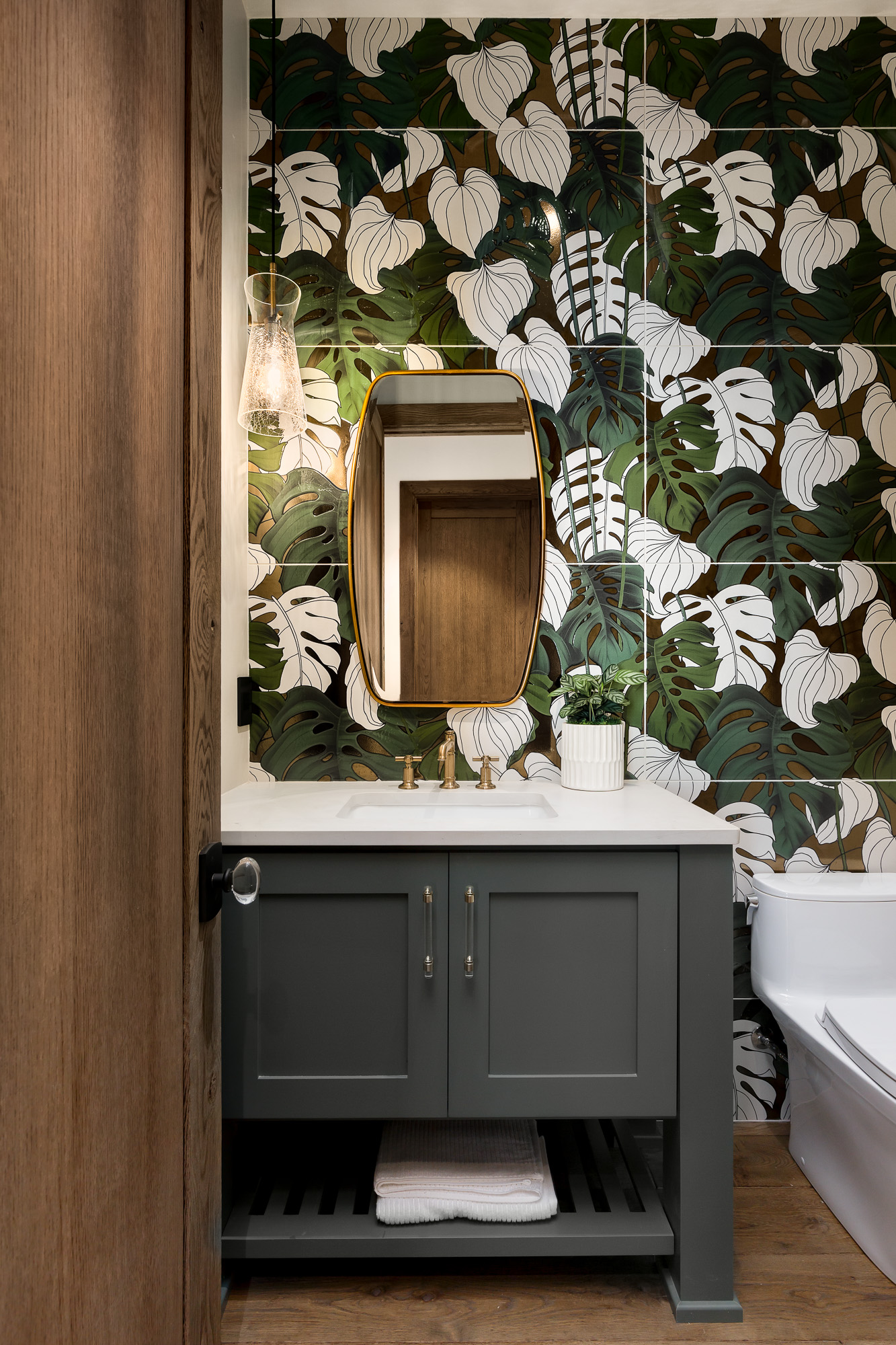 Botanical powder room with brass accents